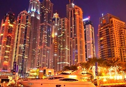 Yacht Outside of a City At Night
